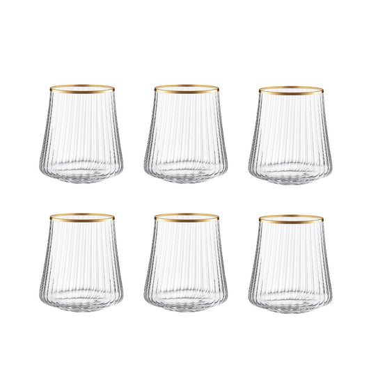 Set of six clear glass tumblers with gold rims on a white background