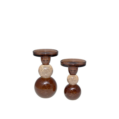 Two brown and beige candle holders on a white background