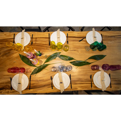Multicolor champagne flutes displayed on festive dining table
