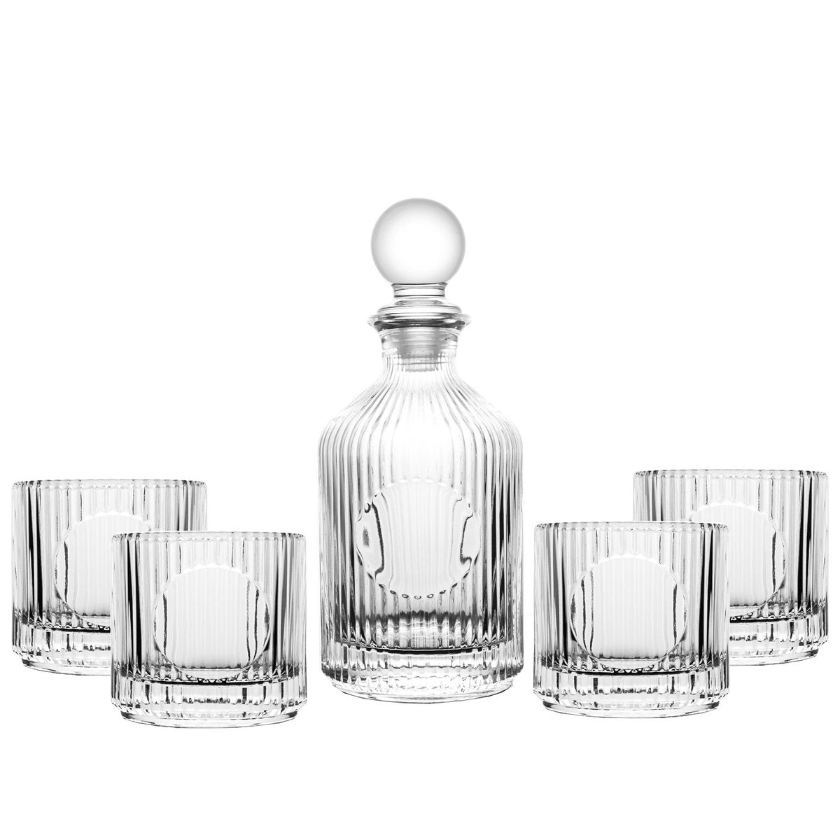 Set of clear glass decanter and tumblers on a white background