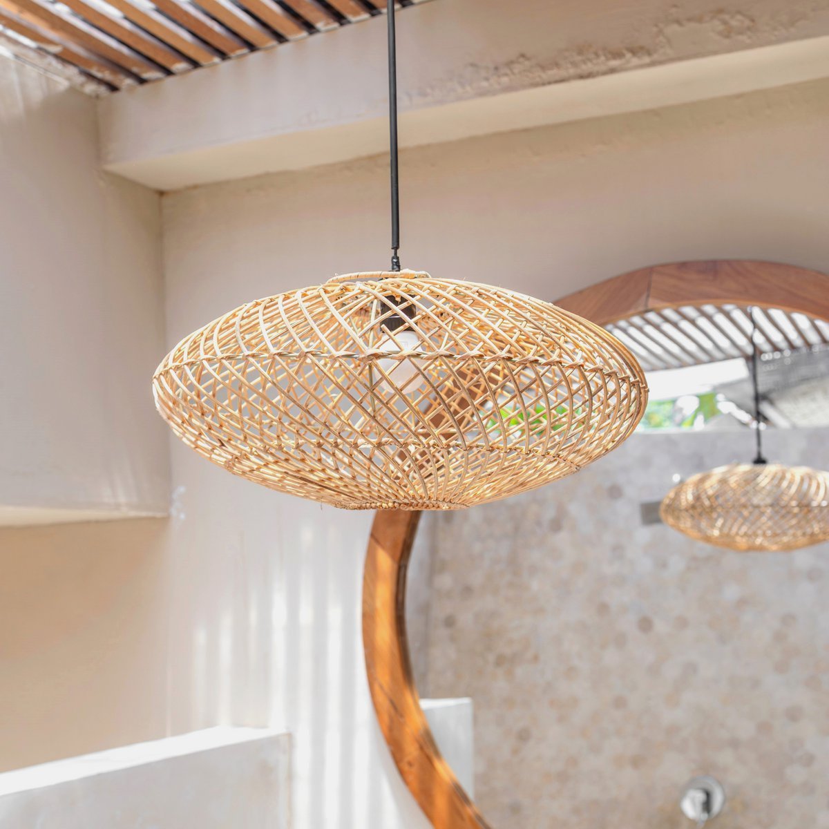 Handwoven rattan lampshade adding cozy style to home décor by CozyVibe

